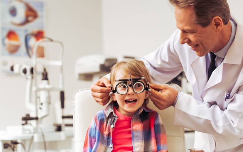 Children smiling and wearing glasses after an eye test at Peter Collins Eyecare